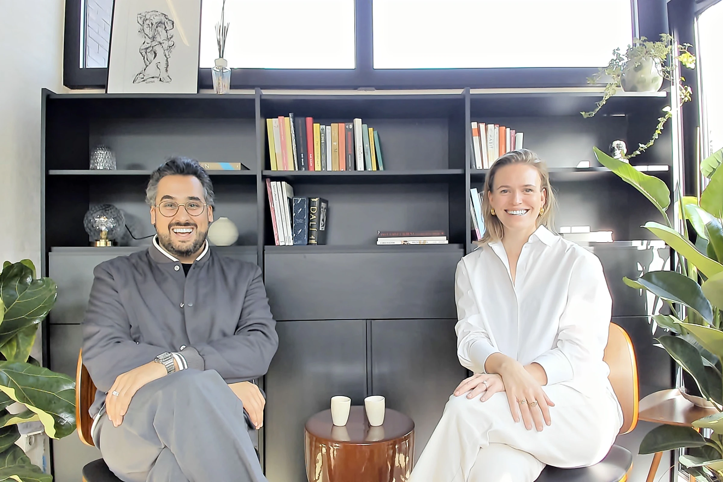 Omid Sajedi and Babette Wuytens, co-founders of YP AI, sitting in front of a bookcase